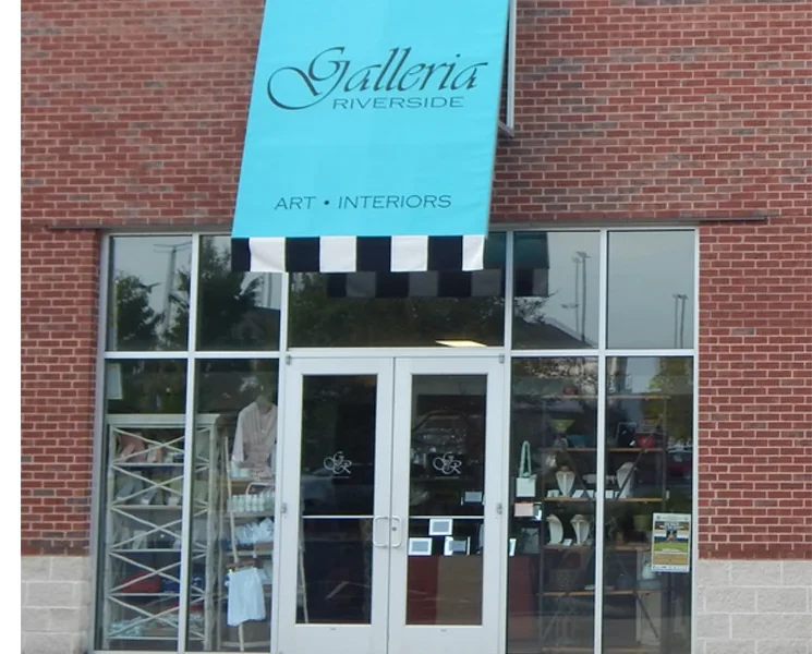 The Galleria Riverside storefront on Rollins Way, its teal banner over the striped awning